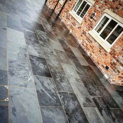 A Stunning stone patio and driveway infront of a house that GFX Ground Effects has worked on in Preston.